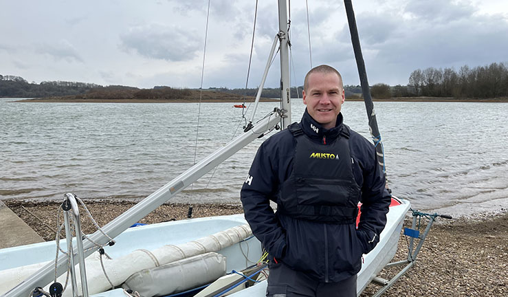 RYA Midlands Regional Development Officer Ben Hodgson by a dinghy on shore.