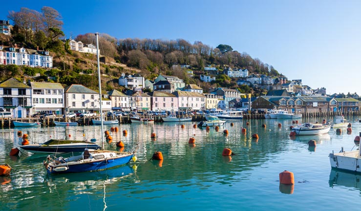 wide shot of blue water and boats at the cornish harbour
