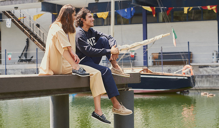 posed shot of two model wearing Sebago shoes on the dockside