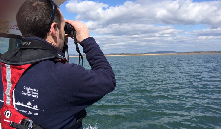 A man using binoculars to look out for wildlife