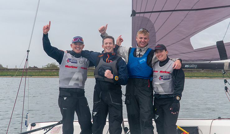 Ted Blowers' team of four with arms in the air and smiling on an RS21 after winning the RYA National Match Racing Grand Finals 2023.