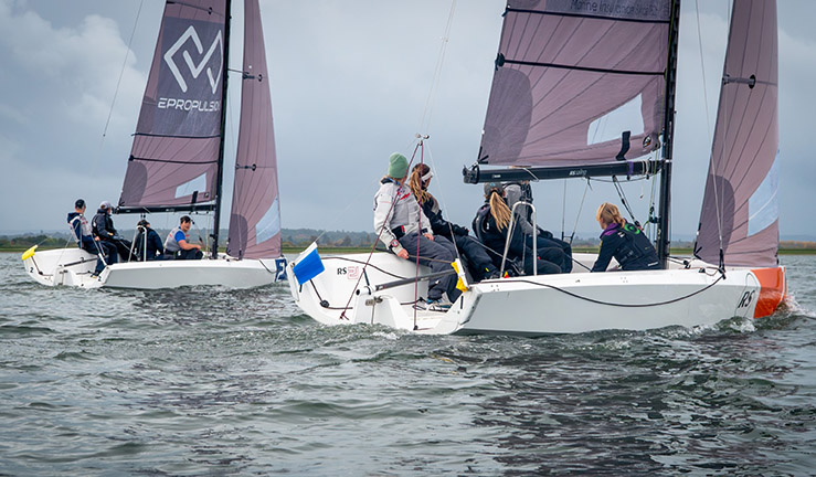 Two teams racing RS21s at the RYA National Match Racing Grand Finals 2023 grey skies and Jenny Cropley's all-female team nearest the camera.