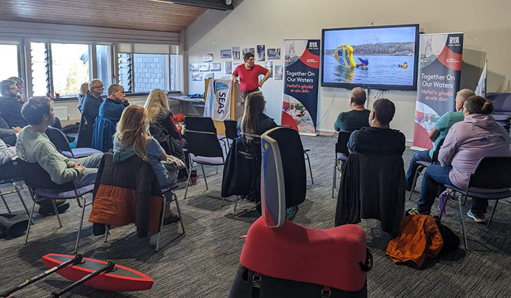 A presentation from SEAS Sailability to a group of delegates inside a training room at Plas Menai for The Big Weekend for clubs, training centres and instructors.