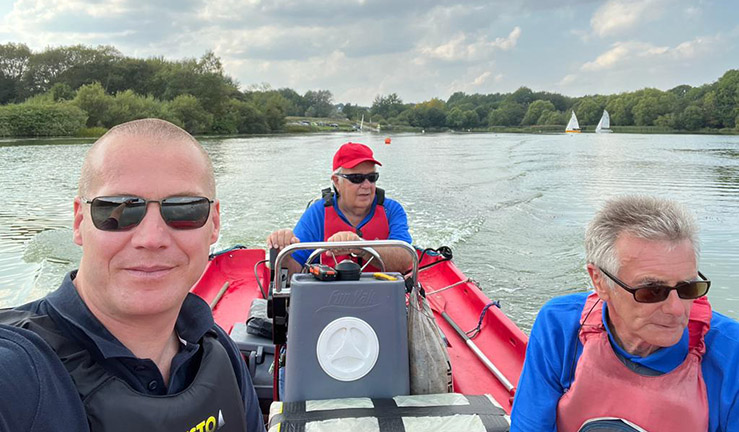 Regional Development Officer Ben Hodgson smiling for a selfie in a powerboat with two members of Telford SC on the water for the club's open day.