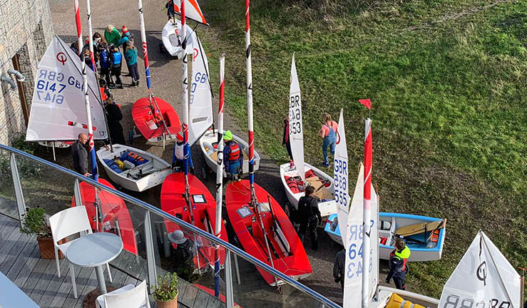 Overhead view taking from Plas Heli national sailing academy Pwllheli of Toppers and Optimists queuing to launch.
