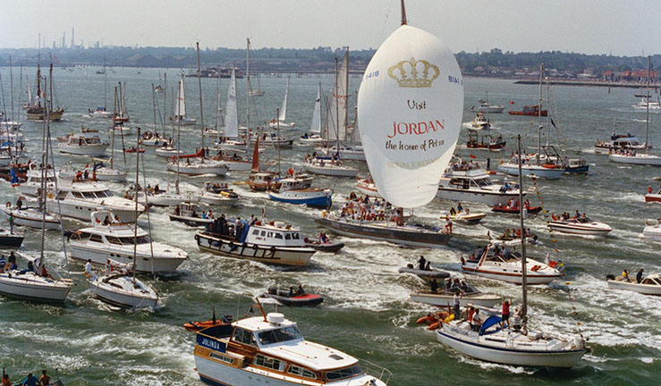 Maiden makes history 28 May1990 as her all-female crew crosses the Whitbread finish line with Jordan spinnaker flying and surrounded by support boats of all sizes welcoming them home.