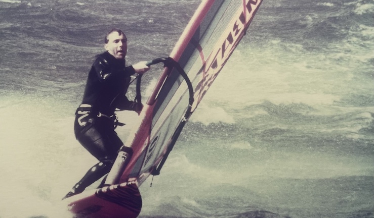 Old photo showing Jamie Johnson windsurfing in breeze and waves during a Windsurf Trainers Course at Plas Menai 1989.