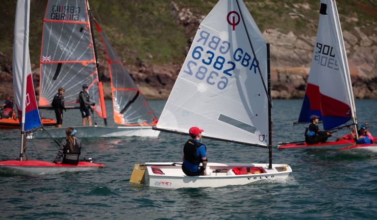 Variety of youth and junior boats (including Optimist, Topper and 29er) on the water at RYA CW OnBoard Festival at Dale 2023.