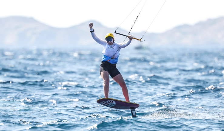 ellie aldridge punches the air in celebration after first medal race win at paris 2024