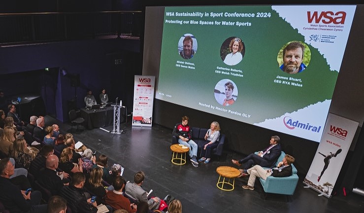 Launch of Clean Water Sports Alliance in Wales with representatives on stage at WSA Sustainability in Sport Conference 2024, including RYA CW CEO James Stuart.