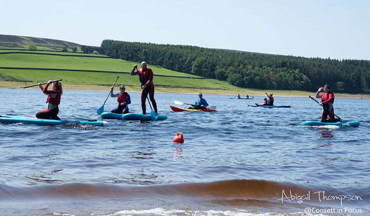 Group of paddleboarders enjoying the water and sunshine at Derwent Reservoir SC.