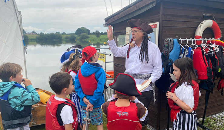 Instructor and children on shore and dressed up for Pirate Day at Gresford SC.