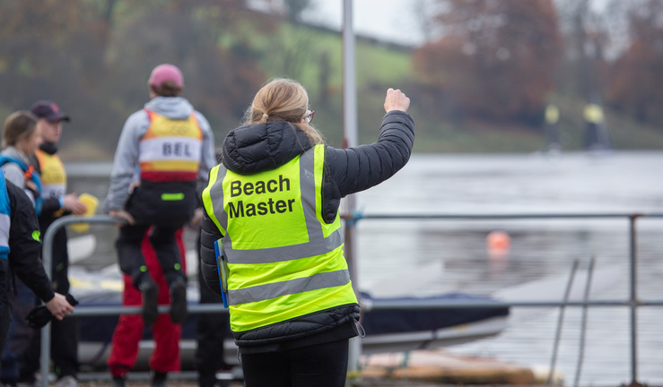 Images of students on a pontoon with fleet of dinghies team racing in the background.