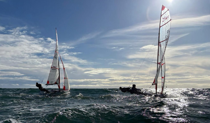 Two 29ers training with RYA Cymru Wales squad on the sea on a winter's day.