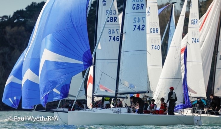 Fleet of J70s racing downwind with blue spinnakers flying as part of a British Keelboat Academy training weekend 2023.