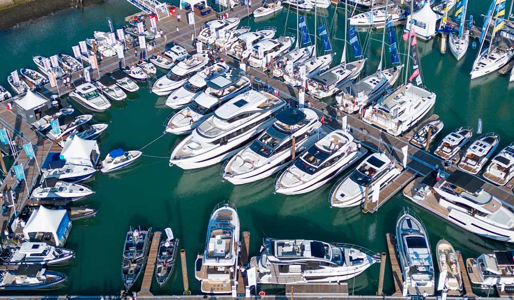 drone shot of motor and sail yachts in marina at southampton international boat show