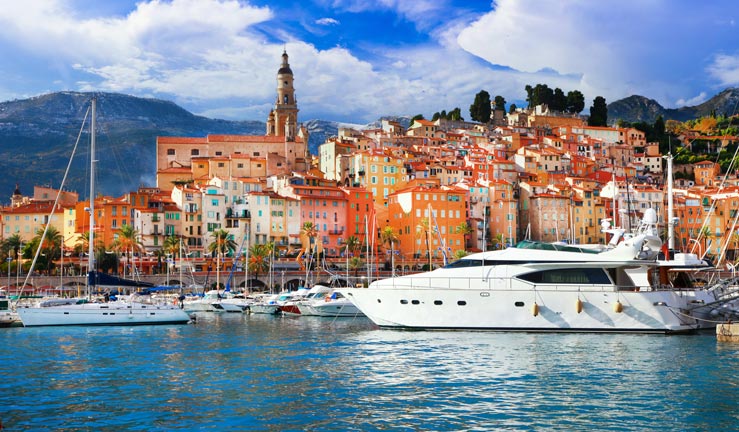 colourful town in south of france with yachts moored in foreground