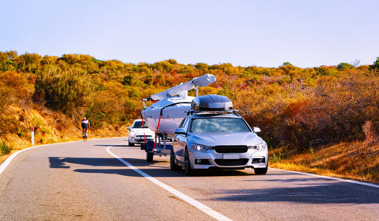 Car towing small boat in europe
