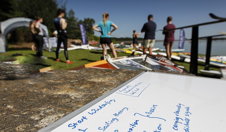 A group of people listening to an instructor.