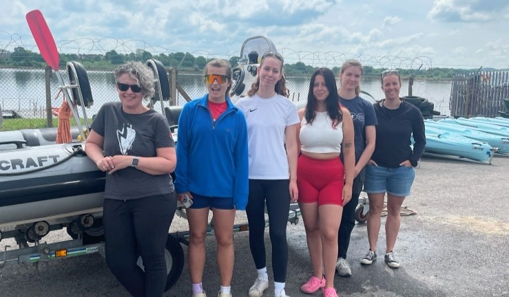 Six women standing by a RIB on a sunny day who passed their RYA Powerboat Instructor qualification as part of the RYA Midlands aspiring female instructors programme.