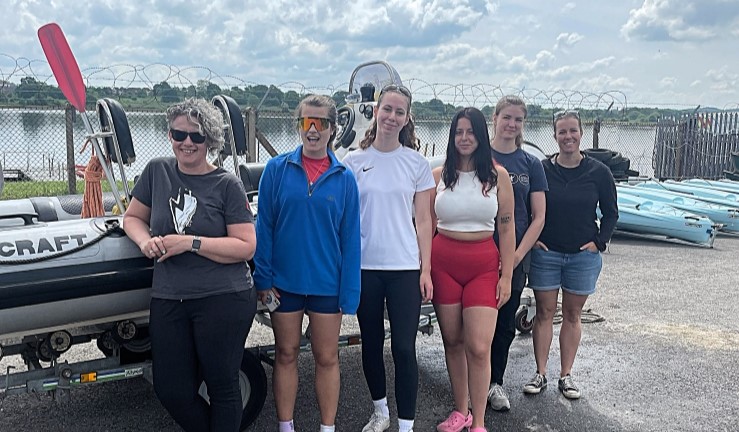 Six women standing by a RIB on a sunny day who passed their RYA Powerboat Instructor qualification as part of the RYA Midlands aspiring female instructors programme.