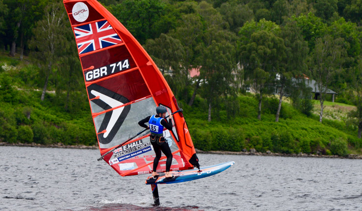 a young sailor competing in the RYA Scotland youth and junior championships on a blue wing foil with a red sail