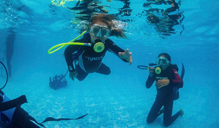 Girls diving in tank at Southampton Boat Show