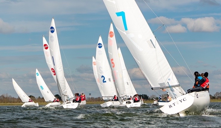 Young teams racing a fleet of Sonar keelboats upwind in sunshine at the first Qualifier of the British Keelboat League 2024 at Queen Mary Reservoir London.