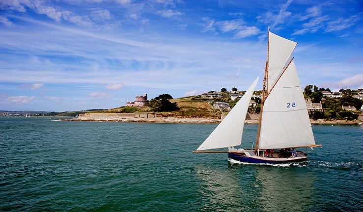 A sail boat on the water on a sunny day