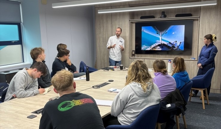 Keelboat workshop with coach presenting to a group using video screen.