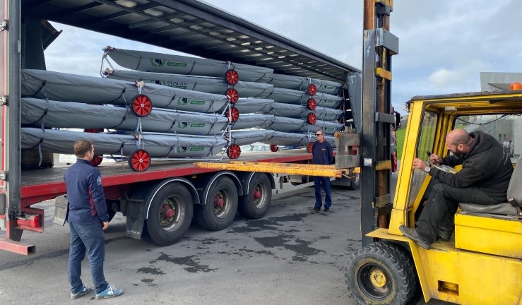 Fork lift truck driver unloading new ILCAs for Welsh Sailing from lorry at Plas Menai.