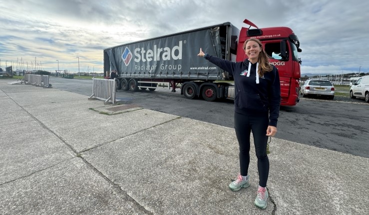 RYA CW Performance Manager Sarah McGovern welcomes a lorry delivering 18 ILCAs from Ovington Boats.