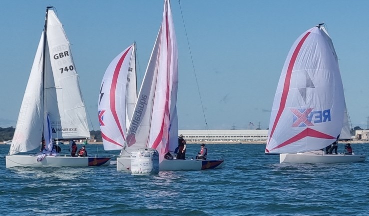 Four J70s (3 with pink and white spinnakers flying) in the sunshine at Royal Southern YC for the British Keelboat League final 2024.