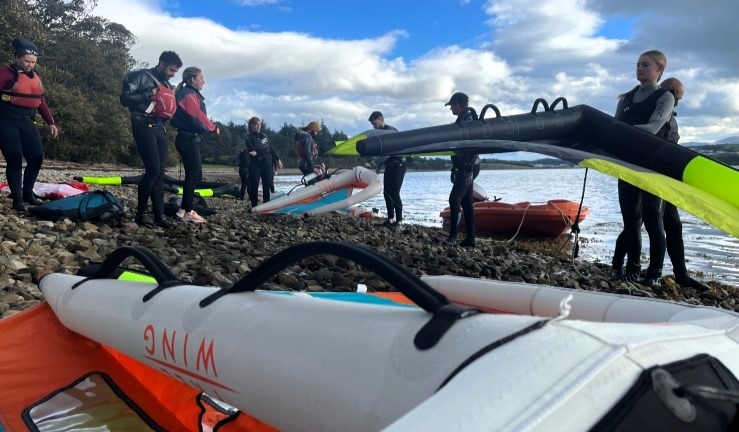 People with winging equipoment on shore at Plas Menai as part of the Big Weekend 2024.