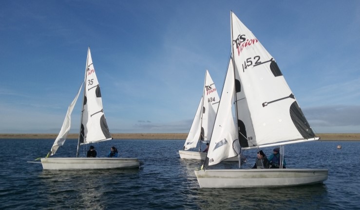 Three RS Vision dinghies on the water as part of a training course at Covenham Sailing Club. 