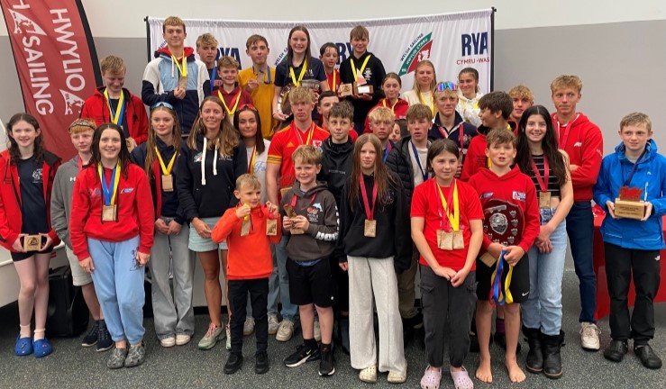 Group picture inside Plas Heli of many prize winners with medals at the Welsh Youth & Junior Championships 2024.