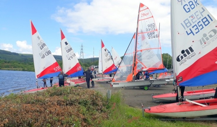 Variety of youth and junior boats launching for a Dragon Series event.