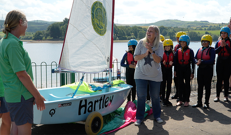 Retiring headteacher Sandra Hartley is surprised with an RYA Impact Award for incorporating sailing as part of her school's outdoor education programme