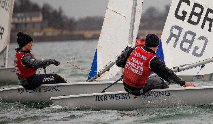 Two Welsh ILCA sailors competing at the Celtic Cup in RYA CW Welsh Sailing branded ILCAs.