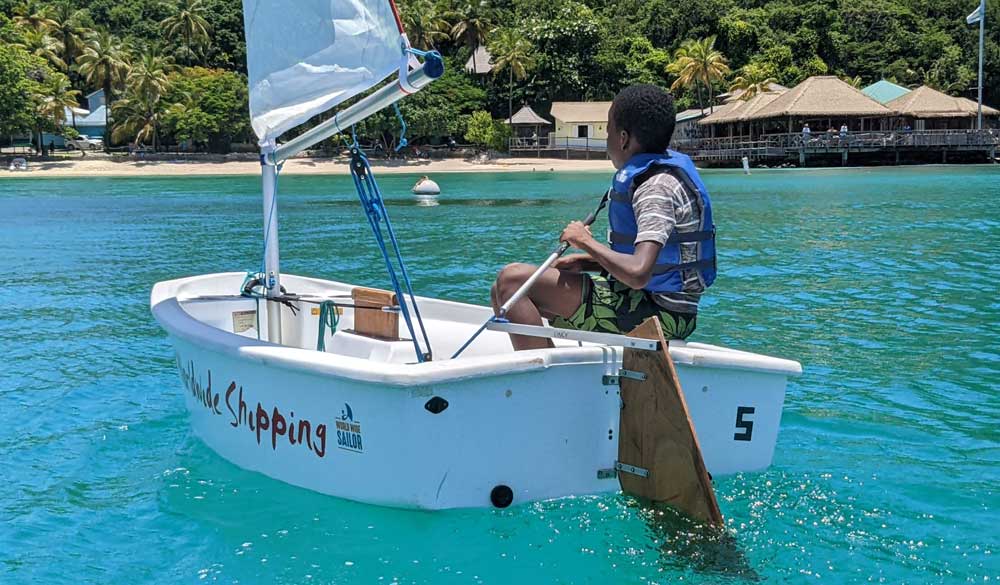 little boy on a dinghy in tropical waters