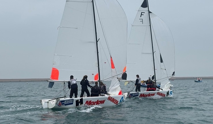 Two teams match racing Elliott 6M keelboats downwind on a grey day at Qualifier 1 of the RYA Match Racing 2025 series.