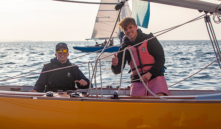 Young men enjoying an evening sailing session