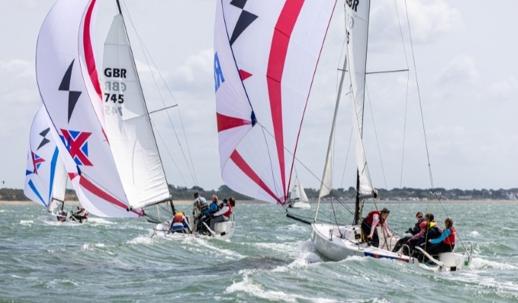 Teams racing J70s downwind with kites flying in breezy sunny conditions at the British Keelboat League Women's Qualifier 2025.