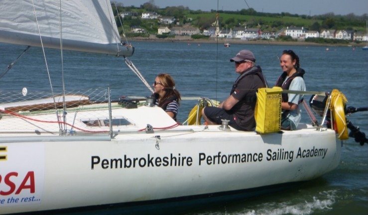 CW Impact Award recipient Richard 'Taff' Owens instructing aboard a PPSA keelboat on a sunny day.