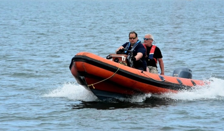 Powerboater Rob Ingram - recipient of an RYA CW Impact Award - driving a RIB with a passenger on board.