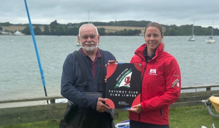 Vice Commodore & Rear Commodore (Training) Ken Newing of Port Dinorwic Sailing Club receives a plaque from Performance Manager Sarah McGovern with Welsh Sailing - Hwylio Cymru branding in recognition of Pathway Club status.