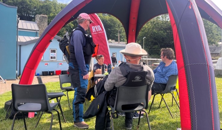 Volunteers under a gazebo at the Welsh Regional Junior Championships 2025.