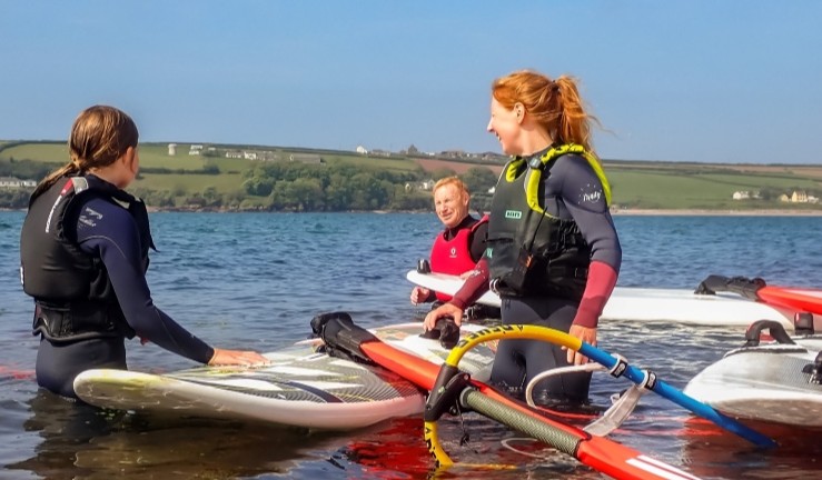 Impact Awardee Sarah Bagley teaching windsurfing on a sunny day at Dale.