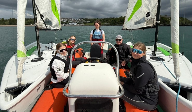 RYA Race Coach L2 participants on a RIB flanked by two training dinghies - RYA CW Big Day Out in Pembrokeshire.