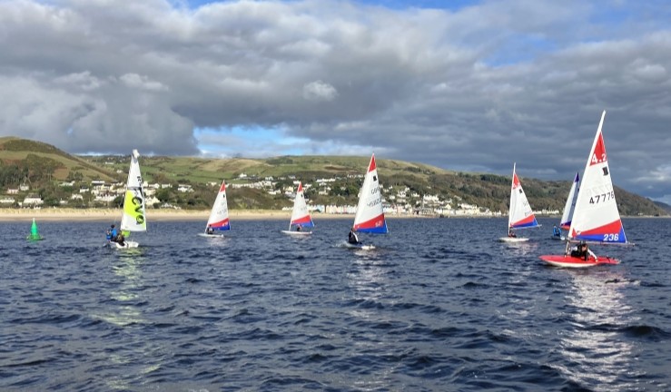 Junior boats on the water in the sunshine at Dovey.